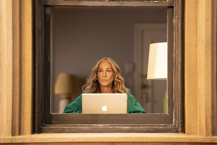 Scene from the Sex And The City sequel showing Carrie writing in her apartment