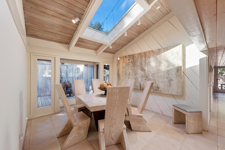 dining room with wooden furniture and skylight