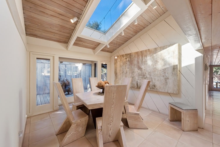 dining room with wooden furniture and skylight 