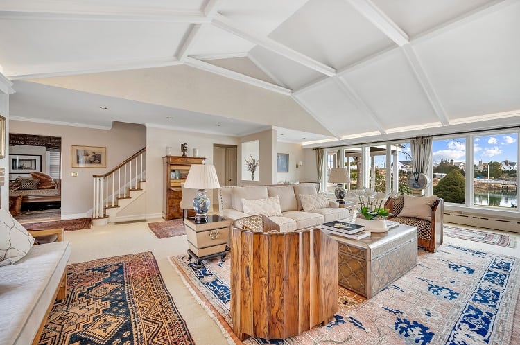 living room with high ceilings and water views 