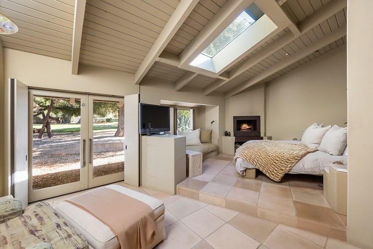 cozy bedroom with fireplace and skylight