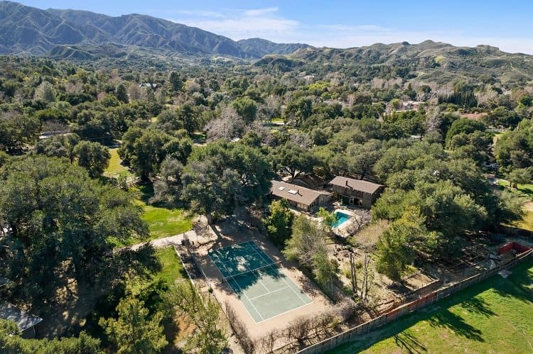 aerial view of actress Linda Gray's property with a pool and tennis court