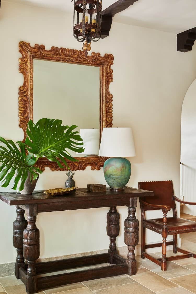 mirror and carved wood furniture inside the castle