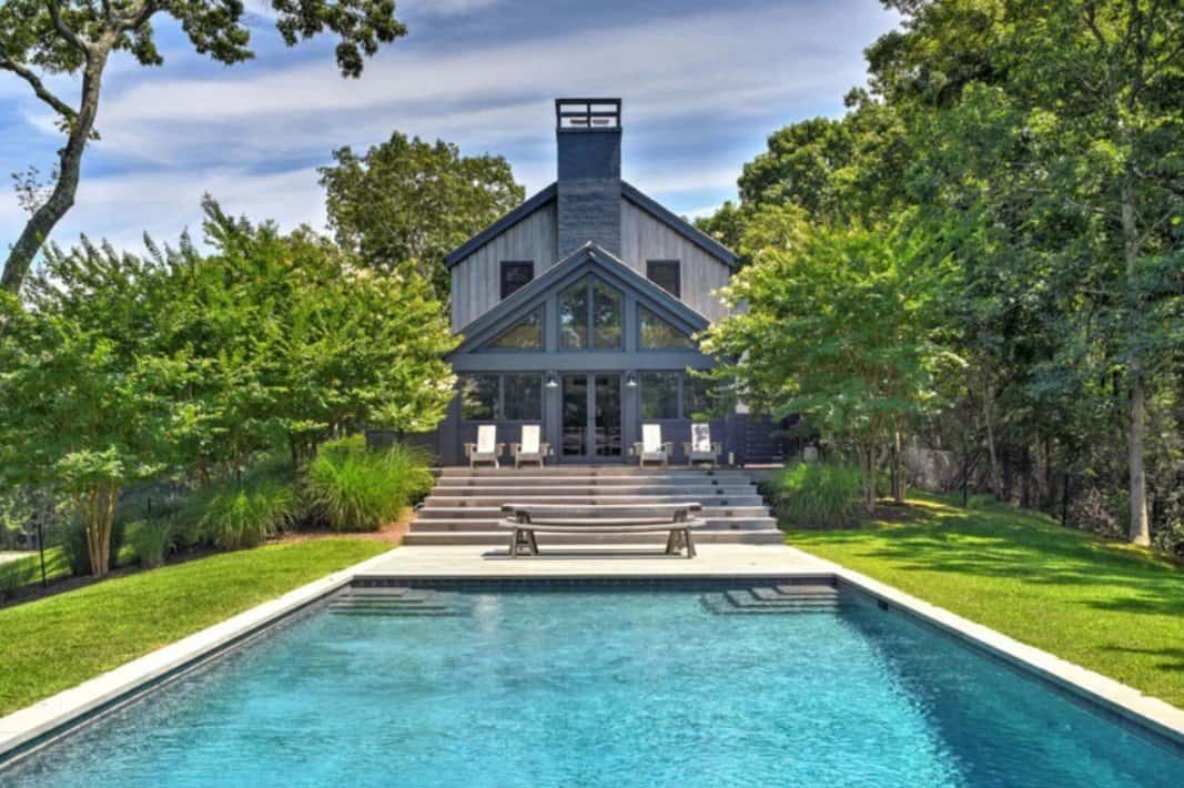 A pool/backyard view of the Sag Harbor house Ellen Pompeo designed, then sold at a profit back in 2019. 