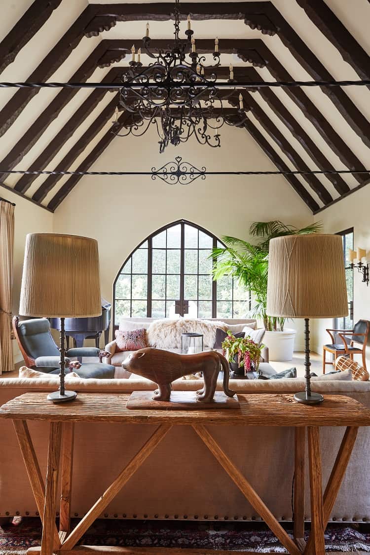 living room with soaring beamed ceilings and arched windows