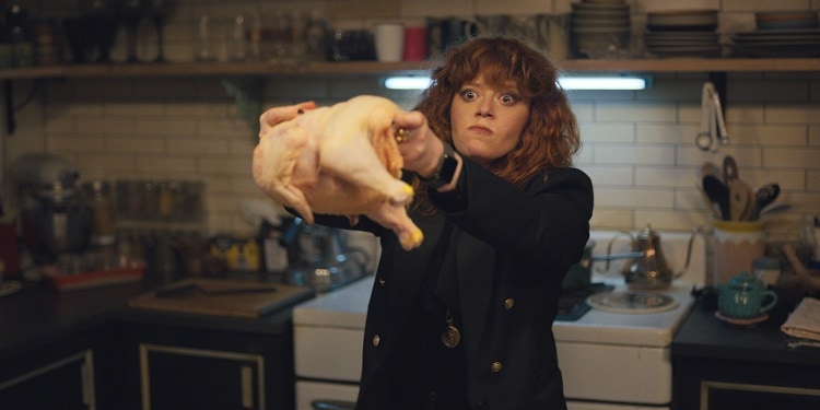 Russian Doll leading character Nadia throwing a chicken on the floor of the kitchen