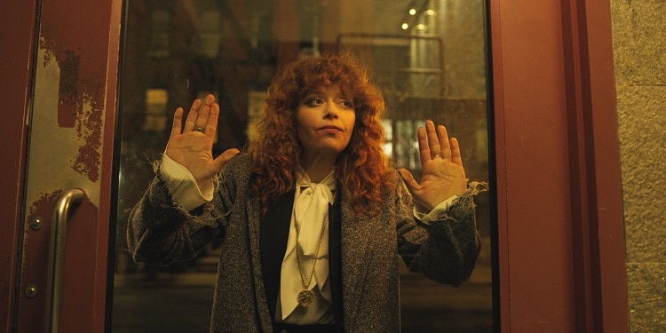 Natasha Lyonne as Nadia, pressed against a glass door