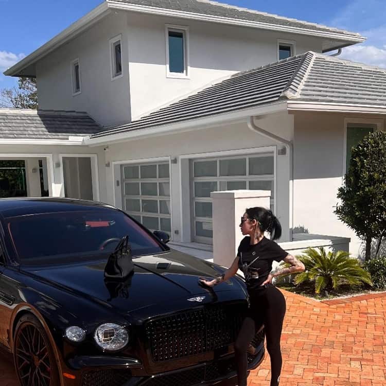 Bhad Bhabie in front of her new house with her luxurious car, a Bentley Flying Spur worth over $200k.