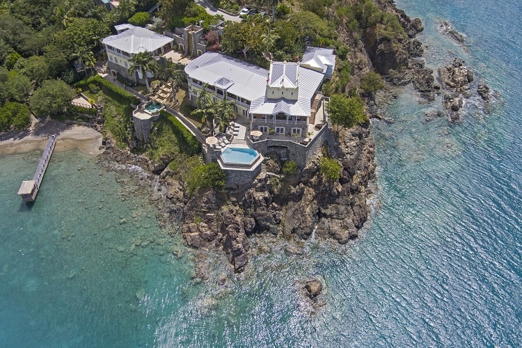 a luxury waterfront estate sitting on a rocky cliff overlooking the Caribbean in Saint Thomas