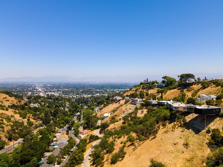 Aerial view of Richard Neutra's platform houses looming over the canyon.