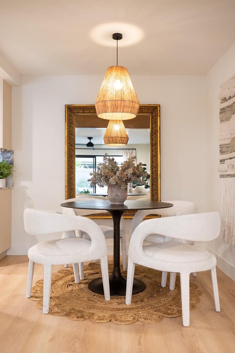 dining room with white chairs inside a Jasmine Roth-designed condo