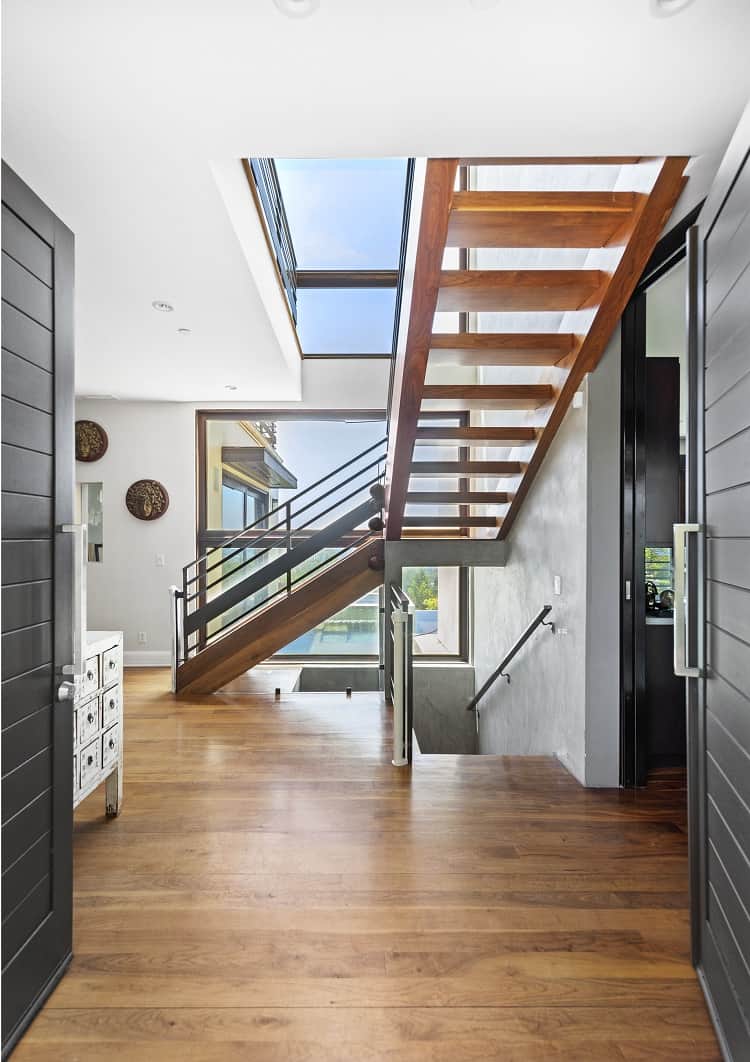 wooden floating staircase inside a celebrity home