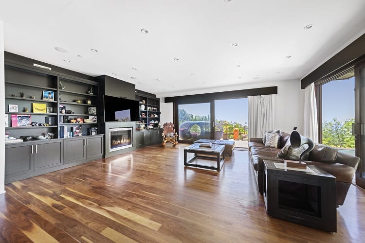 large living room with hardwood floors and a fireplace