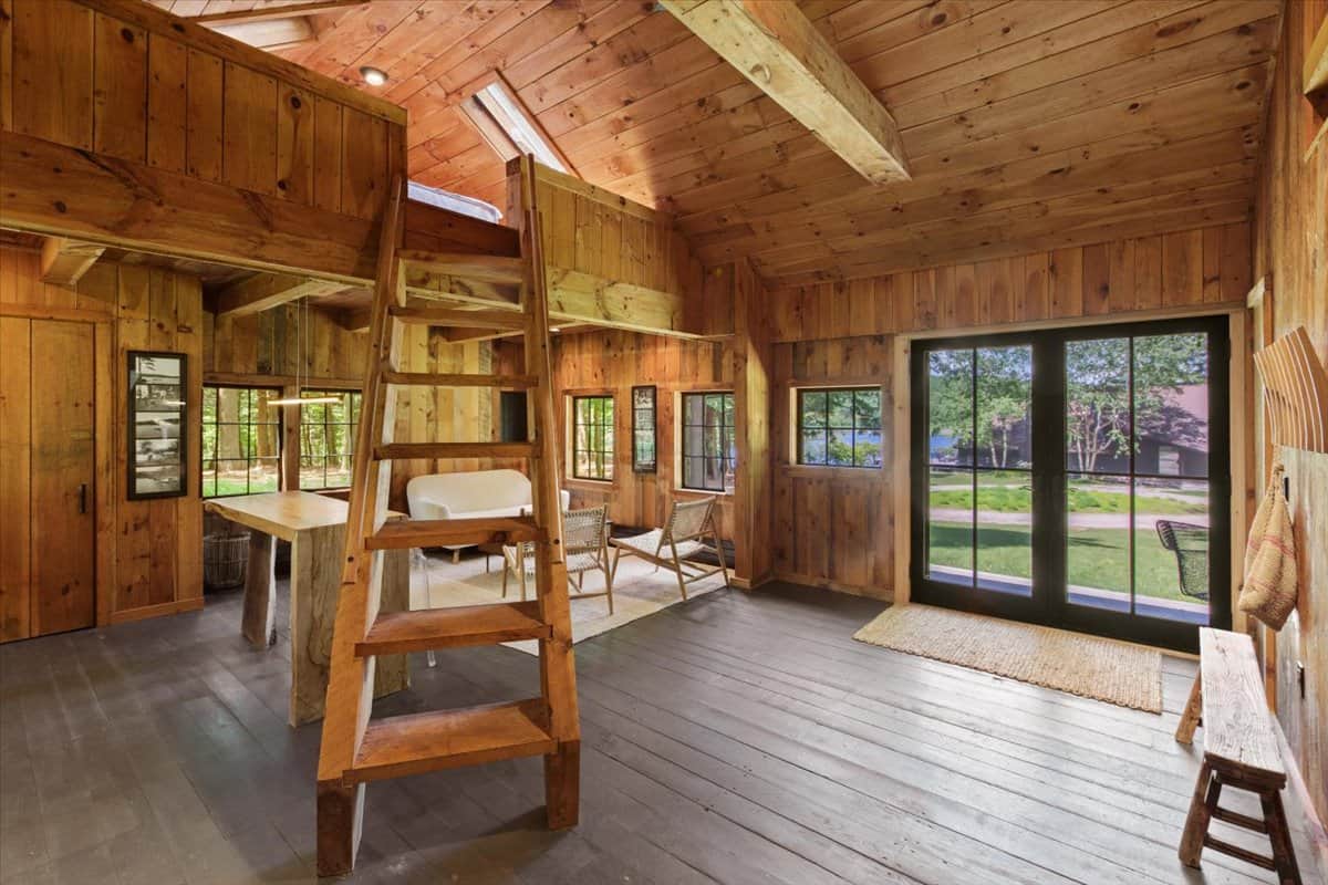 inside the wood-clad cottage with lofted sleeping spaces