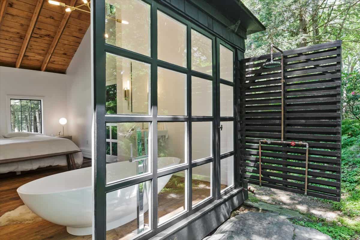 cottage bathroom with windows that open to the outdoors