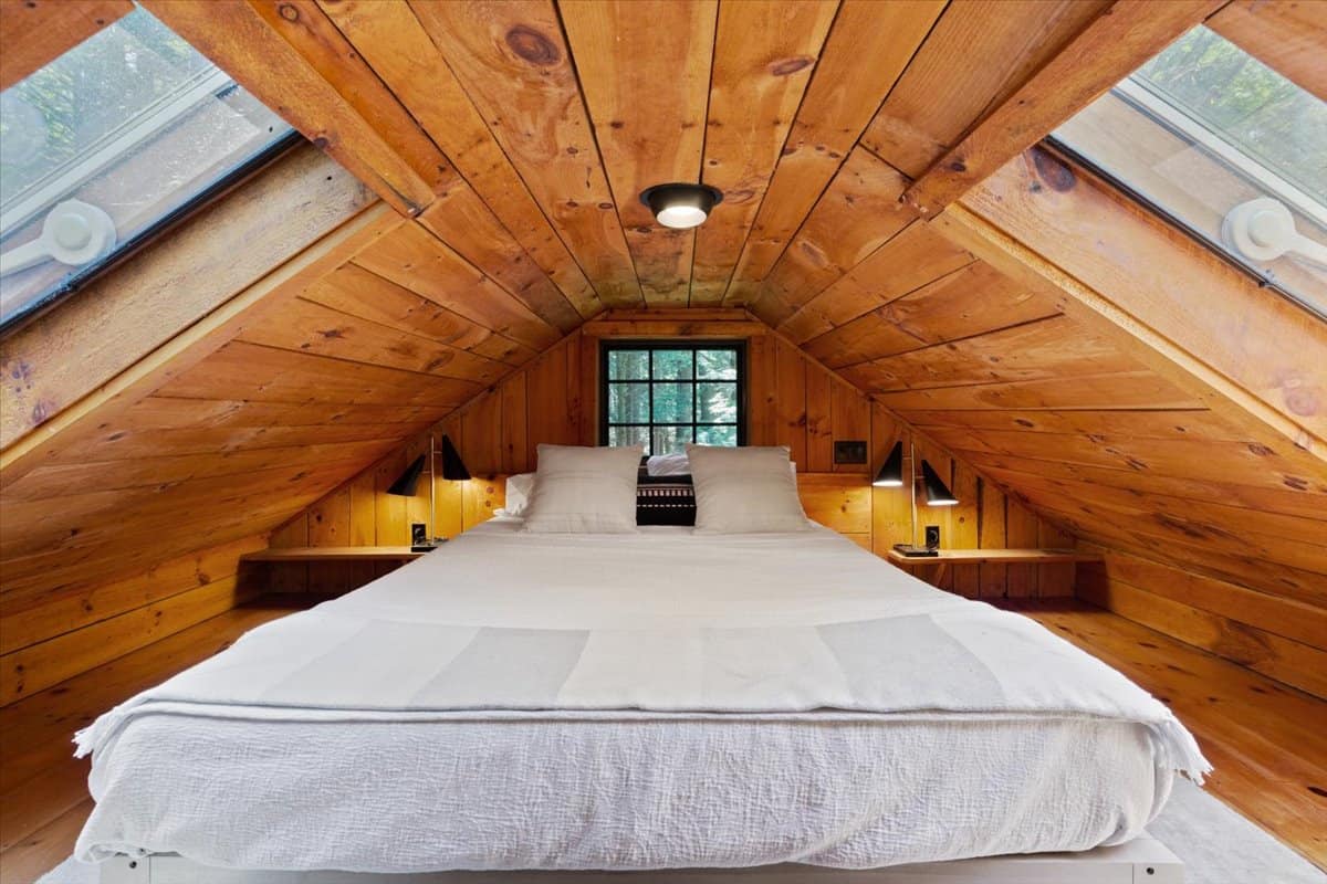 lofted sleeping quarters inside the wooden cottage