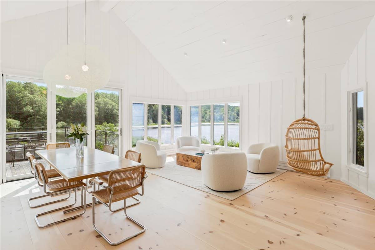 bright living room inside the cottage with white walls and warm wood floors