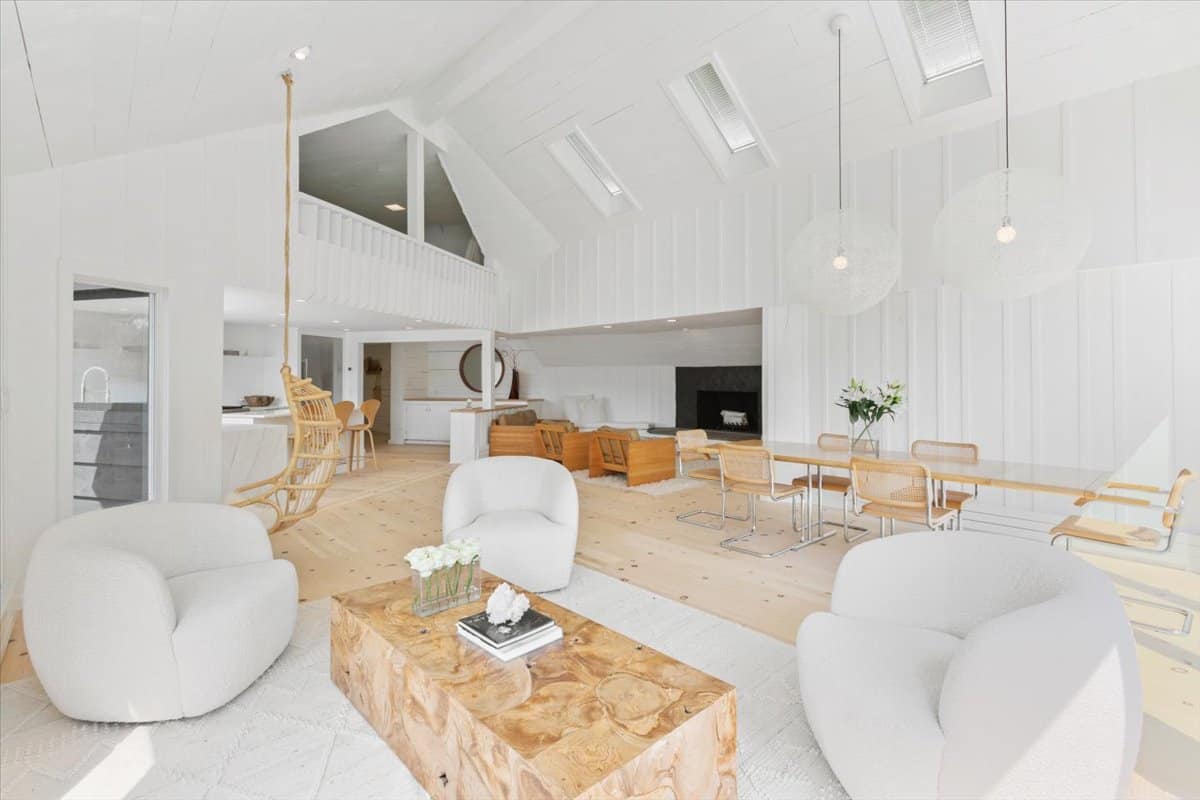 bright living room inside the cottage with white walls and warm wood floors