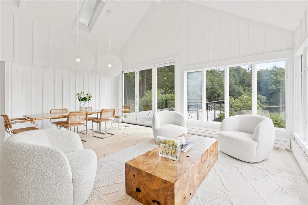 bright living room inside the cottage with white walls and warm wood floors