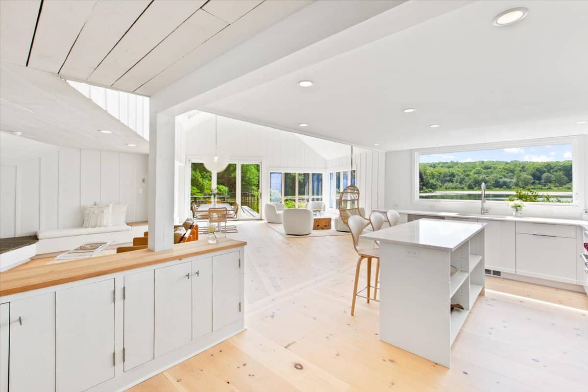 bright kitchen inside the cottage with white walls and warm wood floors