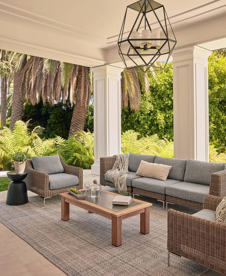 wicker outdoor seating: sofa and armchairs with a coffee table in front