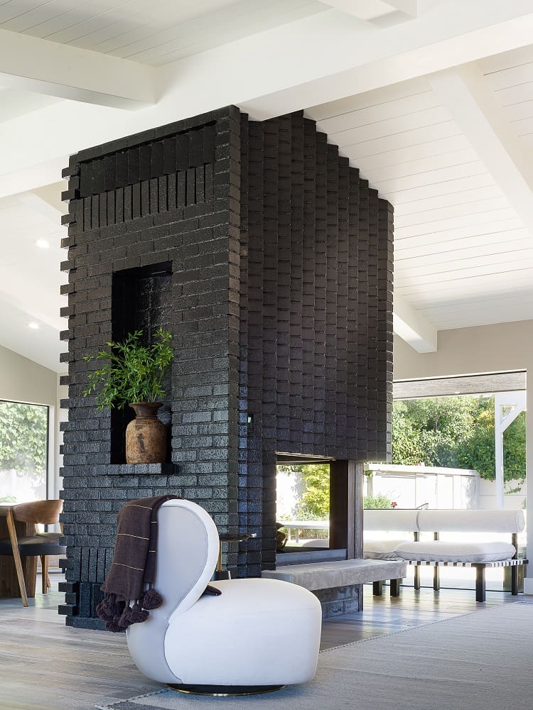 tree-sided black brick fireplace inside Valerie Bertinelli's house