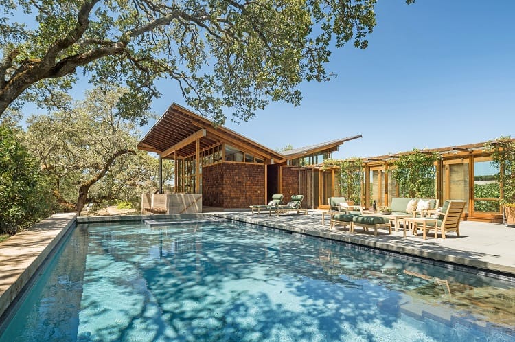 wood and brick guest house and pool of the Meteor Vineyard Estate