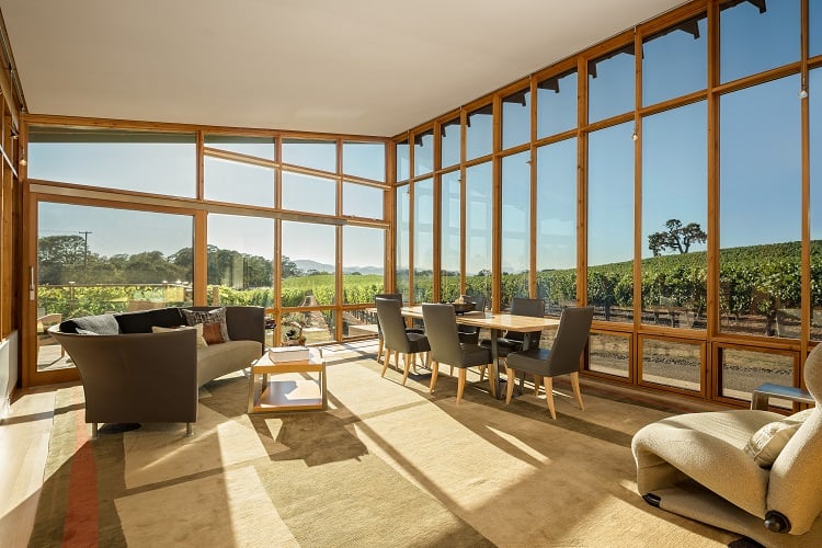 living area with large walls of glass inside the Meteor Vineyard Estate