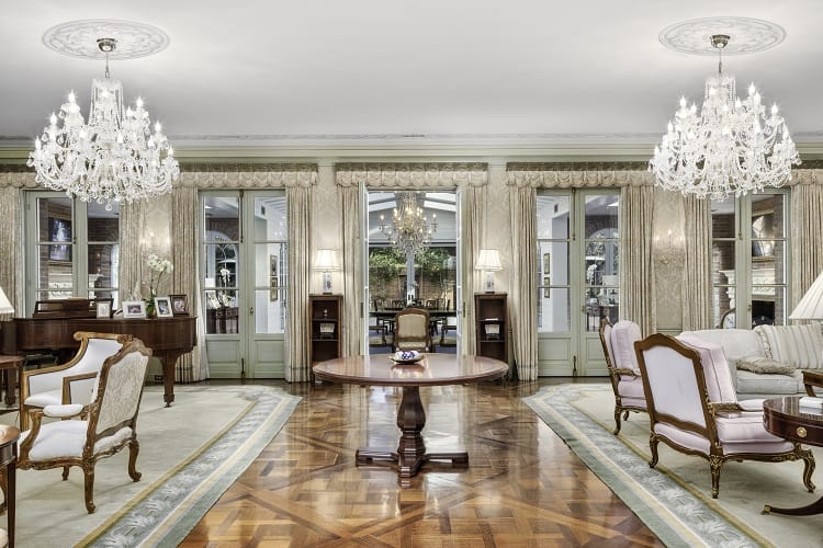 elegant living room with chandeliers inside Foxhill Estate in La Jolla, San Diego