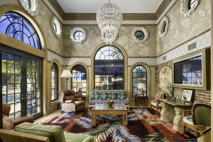 imposing living room with a crystal chandelier inside Foxhill Estate in La Jolla, San Diego