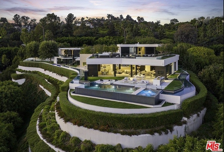 aerial view of a Marc Whipple-designed modern mansion with a wraparound pool