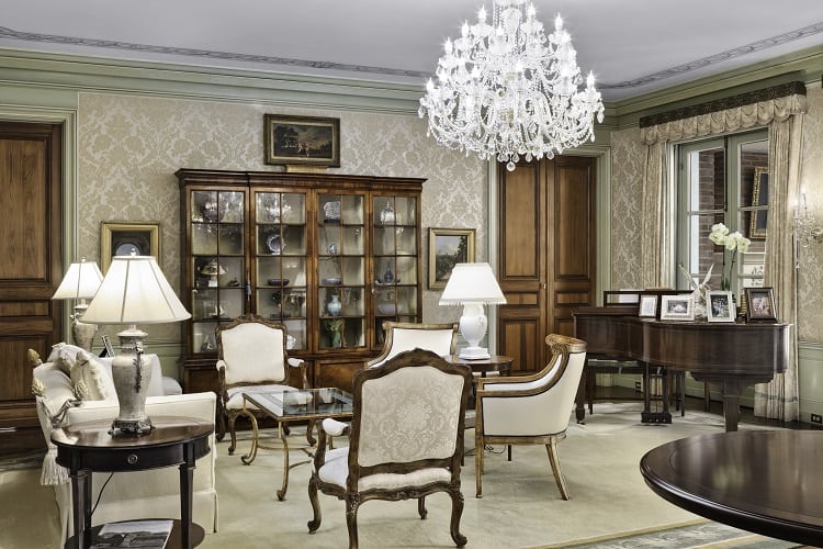 seating area with a piano and chandelier inside Foxhill Estate in La Jolla, San Diego