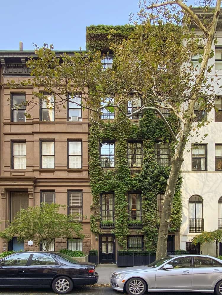 exterior of Gloria Vanderbilt's former house in New York City, covered in ivy