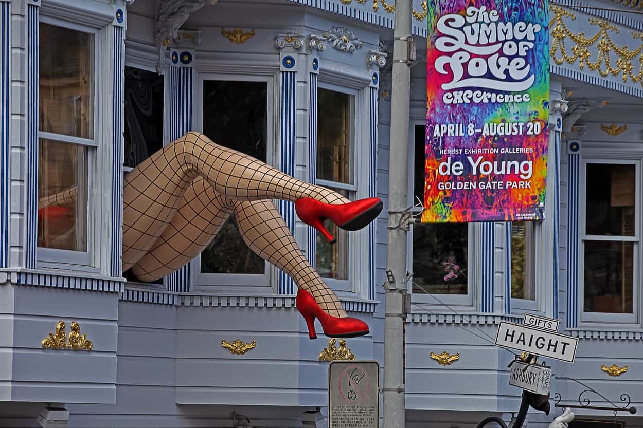Two legs in black fishnet stockings and red high heels sticking out of the upstairs window of the Piedmont Boutique in the Haight-Ashbury, San Francisco