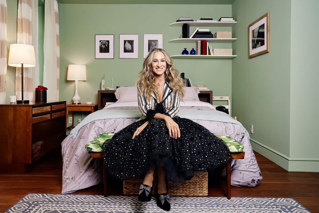 Sarah Jessica Parker in the bedroom on Carrie Bradshaw's apartment, briefly listed on Airbnb in 2021.