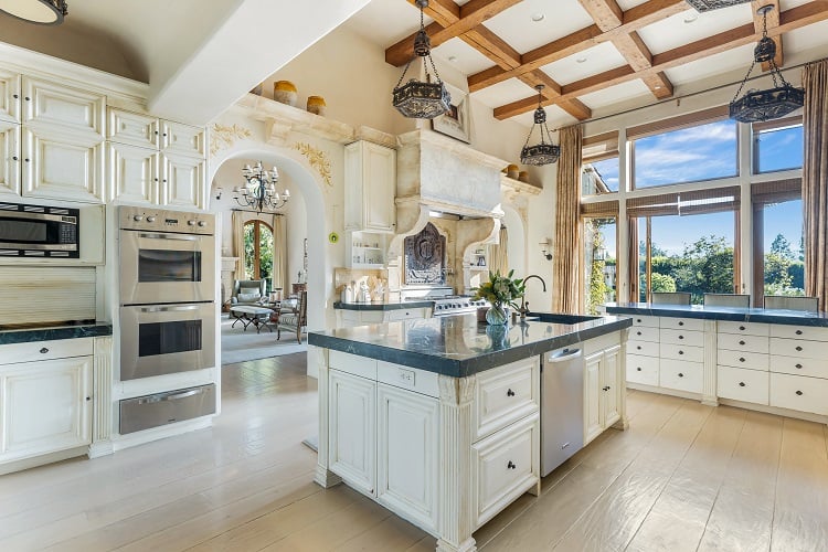 elegant white kitchen with beam ceilings inside Sugar Ray Leonard's house