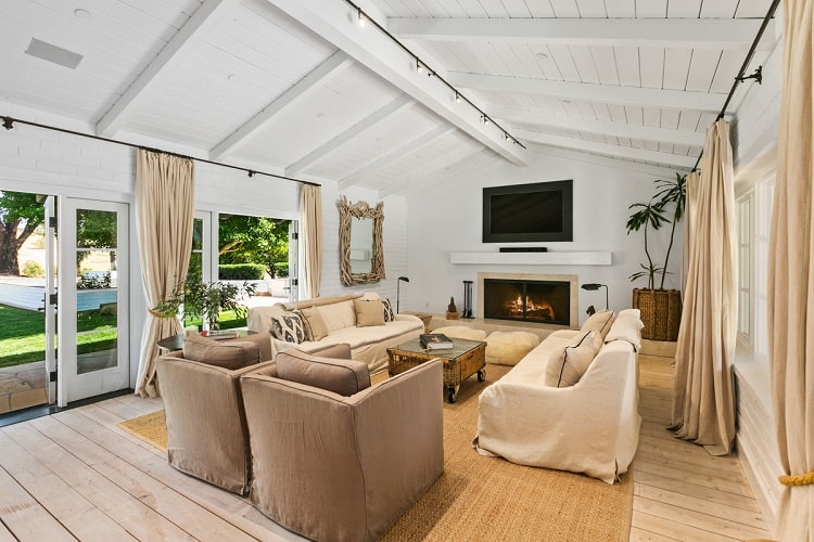 living room with vaulted ceiling and fireplace inside Sandra Bullock's house