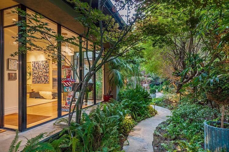 meandering pathway next to the glass entrance