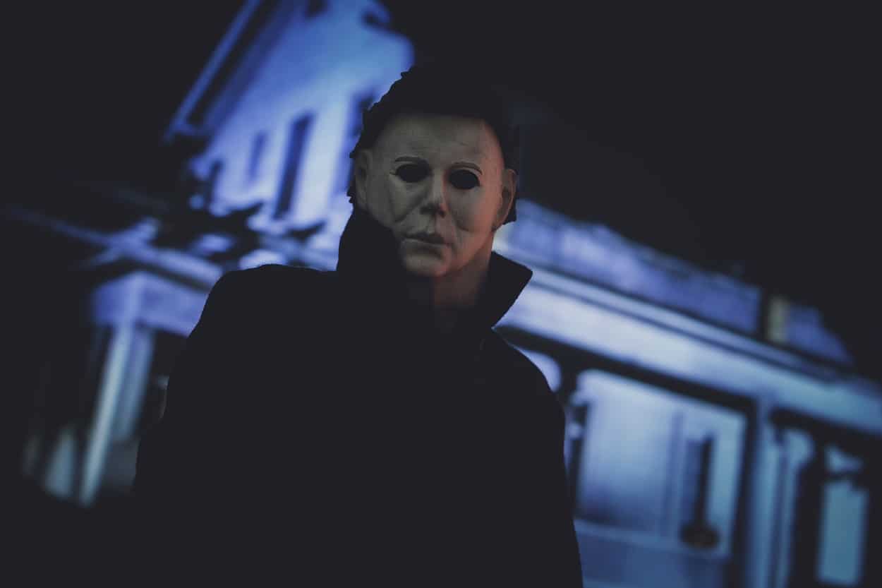 horror movie character Michael Myers with the Halloween house in the background