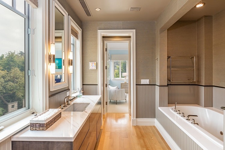 luxuriously appointed bathroom with soaking tub and marble countertops