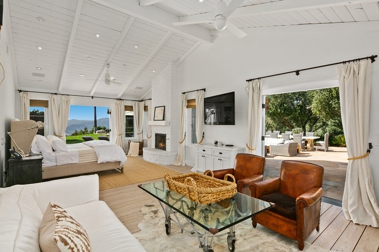 large bedroom with seating area and french doors inside Sandra Bullock's house