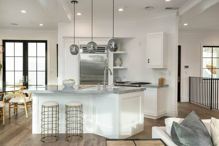 white kitchen with hanging lights