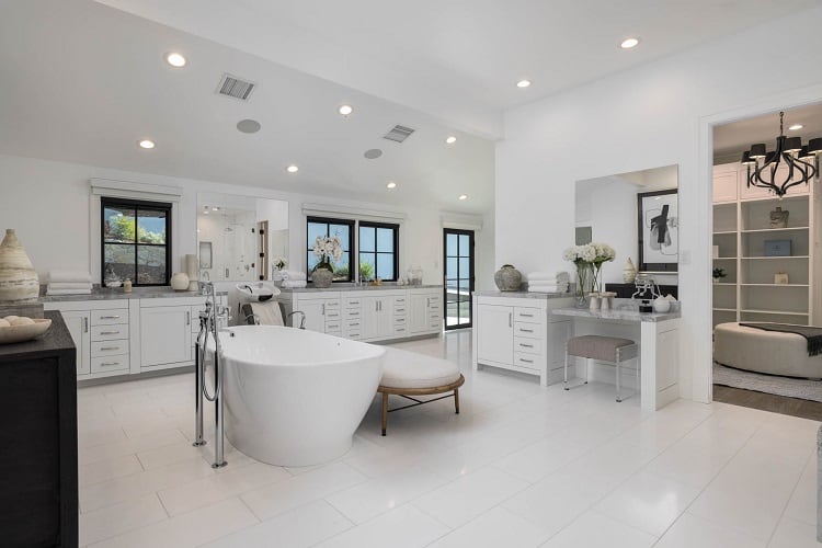 large white bathroom with a tub in the middle