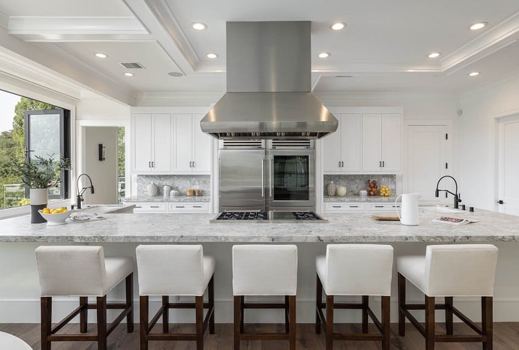 luxurious kitchen with white furniture and marble countertops