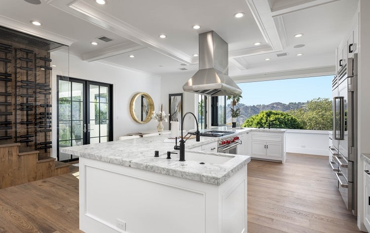 luxurious kitchen with white furniture and marble countertops