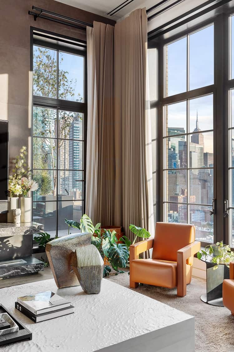 sitting area with orange seat  inside Trevor Noah's penthouse