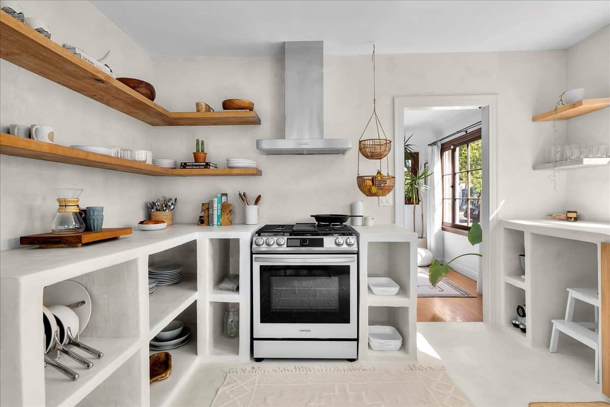 The Blanco Bungalow kitchen, with grey palette complemented by warm wood shelves