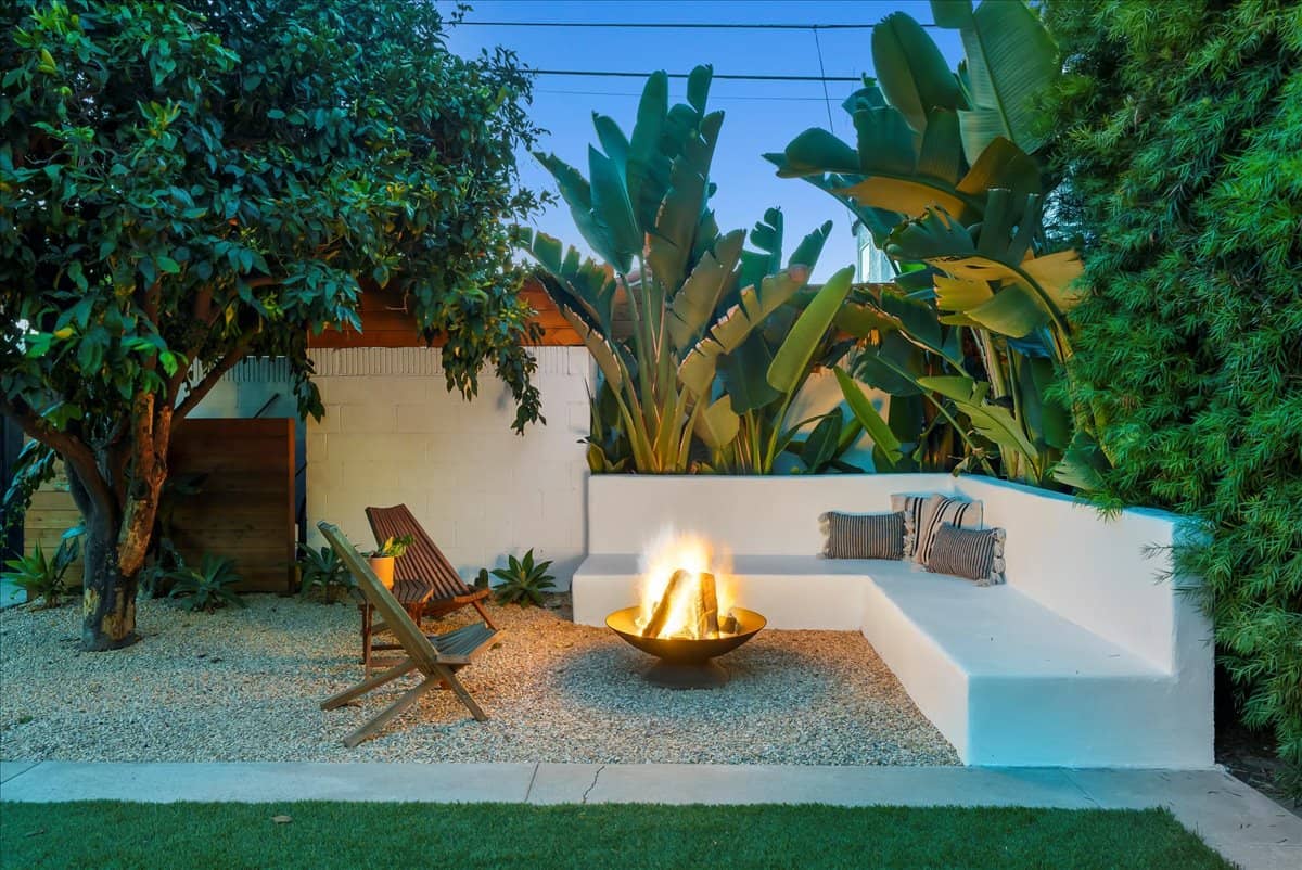 fire pit with seating in a lovely backyard