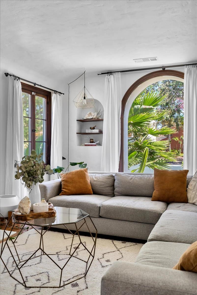 living room with beige sofa and arched windows 