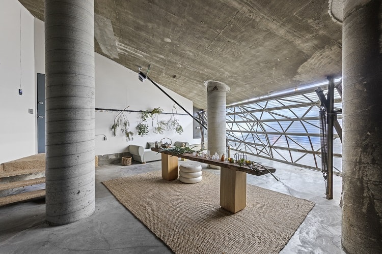 artist workshop with concrete columns inside a dome house